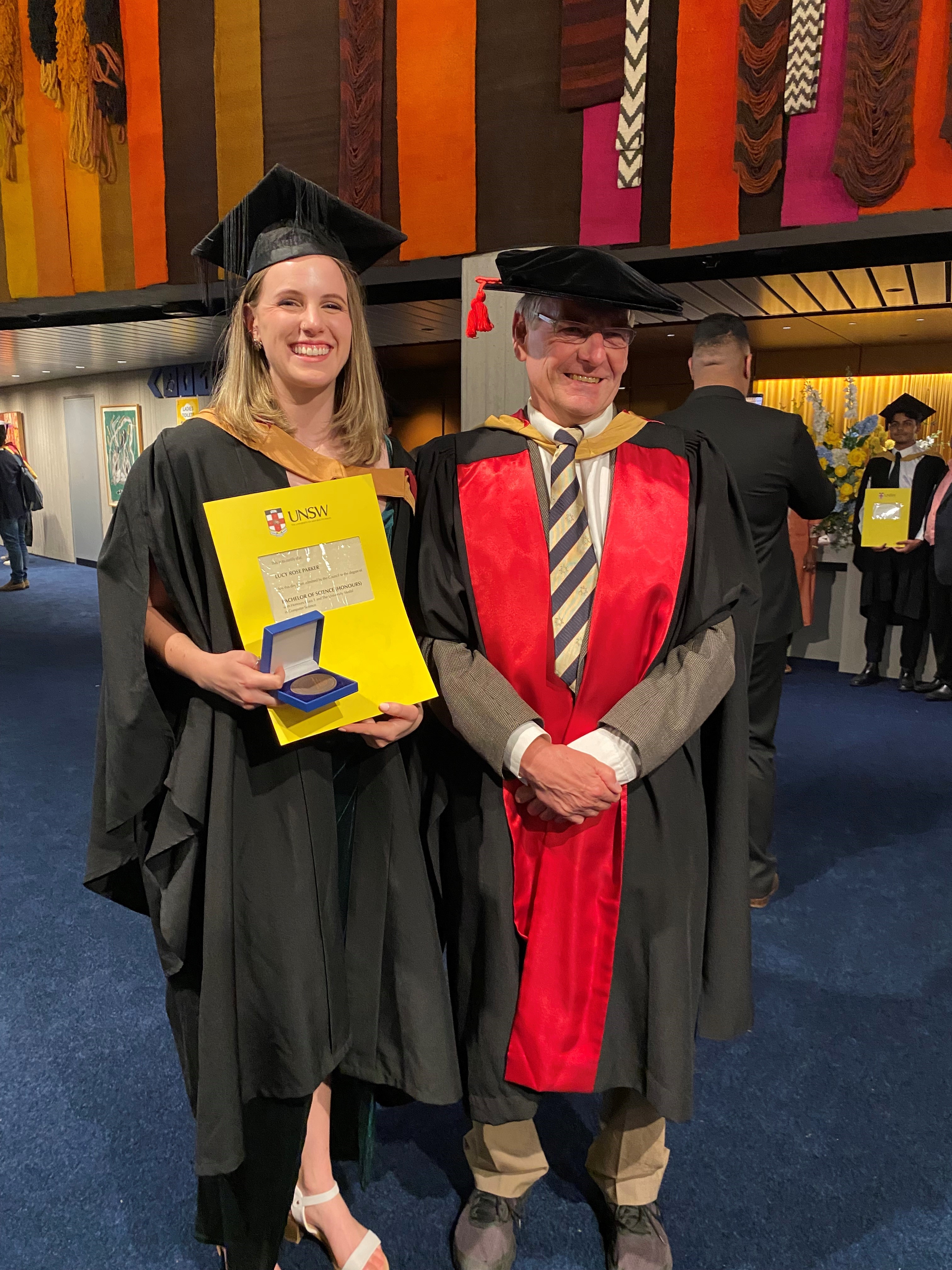 Lucy Parker and her proud supervisor Gernot Heiser at Lucy's graduation, where she won the University Medal.